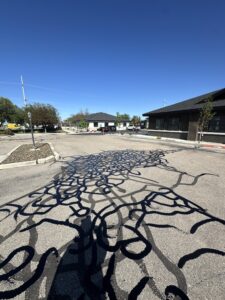 squiggly lines from water damage to asphalt parking lot